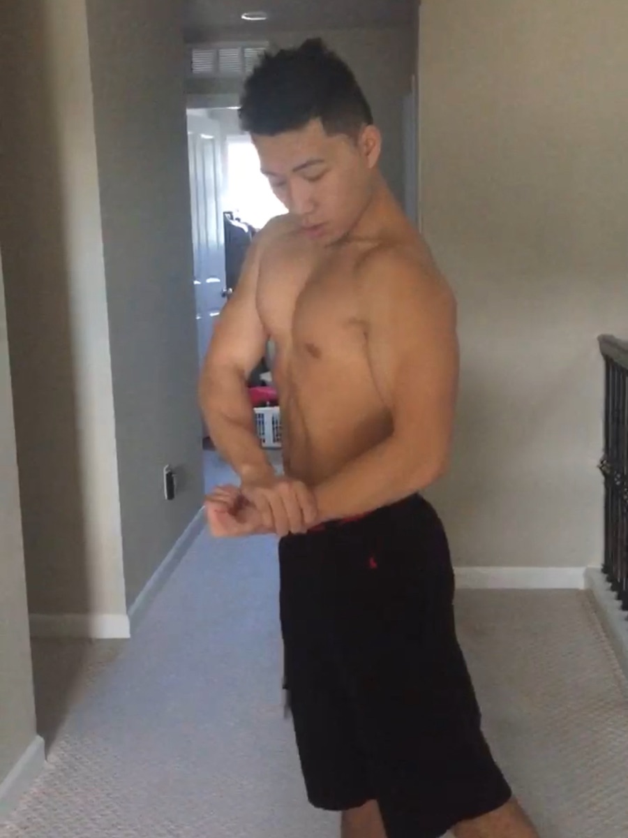 Zack after losing the weight, lean but undersized, flexing in a hallway